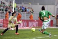 Saint-Etienne's Pierre-Eme Aubameyang (R) kicks to score a goal on April 24, 2013